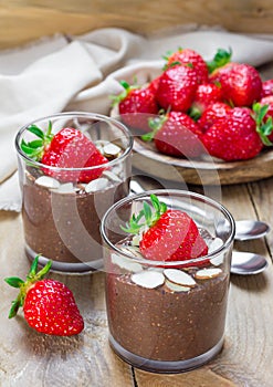 Chocolate chia seed pudding with almond slices and strawberry