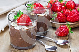 Chocolate chia seed pudding with almond slices and strawberry