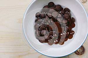 Chocolate chip and coconut oil in a bowl on the wood, Top view