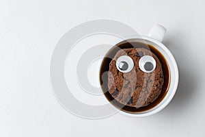 Chocolate chip cookie character floats in Cup of tea. Coffee Cup with cookies on white background. Top view