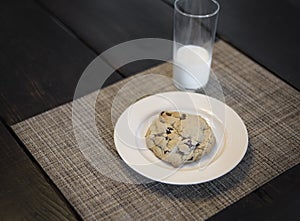 Chocolate Chip cookie and milk served on wooden table