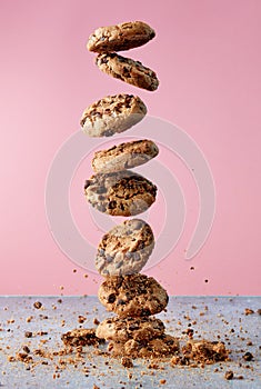 Chocolate chip cookies falling in stack