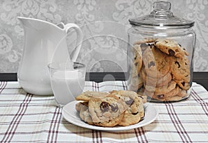 Chocolate Chip Cookies in a glass canister and on a plate.
