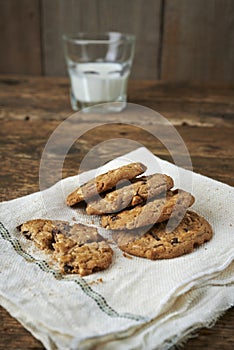 Chocolate chip cookies with glass of milk, on withe cheesecloth