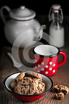 Chocolate Chip Cookies and milk on dark