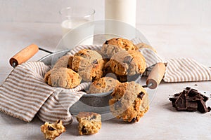 Chocolate chip cookies with milk on white background