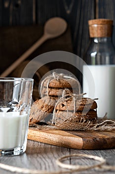 Chocolate chip cookies and milk on wooden background