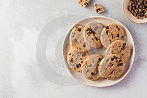 Chocolate chip cookies on a plate with a gray background. Copy space