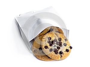 Chocolate chip cookies in white paper bag isolated on white