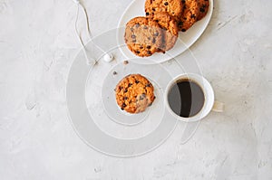 Chocolate chip cookies in a white plate cup of coffee and heads