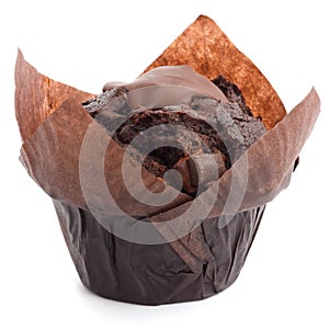 Chocolate chip muffin in brown wax paper