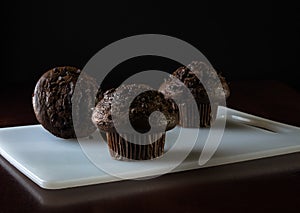 Chocolate chip muffins on black background