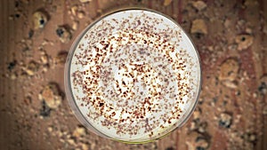 Chocolate chips floating in the glass of milk