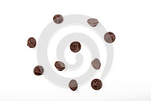 Chocolate chips scattered on white background