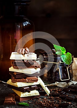 Chocolate / Chocolate bar / chocolate background/chocolate tower and glass with chocolate beans decorated with mint leaf.