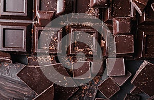 Chocolate chunks. Chocolate bar pieces. A large bar of chocolate on gray abstract background.