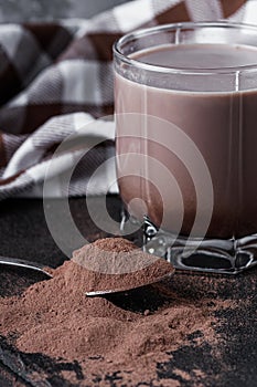 Chocolate cocoa milk powder on a black stone background