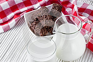 Chocolate cocoa milk powder on a white wooden rustic background