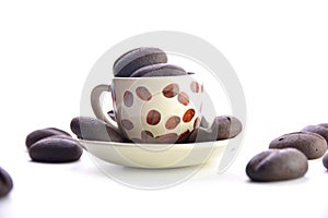 chocolate coffee beans in a mug on a saucer, white background
