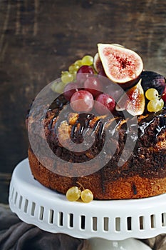 Chocolate coffee cake decorated with fresh fruits