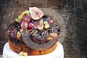 Chocolate coffee cake decorated with fresh fruits