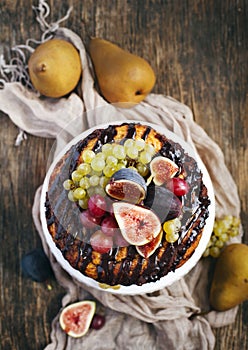 Chocolate coffee cake decorated with fresh fruits