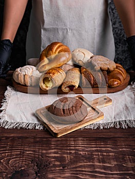 Chocolate concha bread on a rustic wooden table