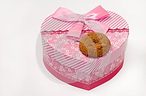 Chocolate cookie and heart shaped pink box with bow