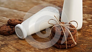 Chocolate cookie with milk on wooden table. Homemade cookies.