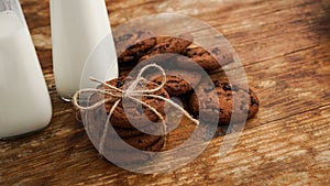 Chocolate cookie with milk on wooden table. Homemade cookies.