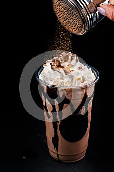 Chocolate cookie milkshake in tall mugs with chocolate whipped cream