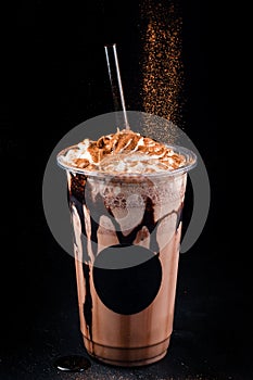 Chocolate cookie milkshake in tall mugs with chocolate whipped cream