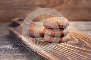 Chocolate cookie on a wooden cutting board