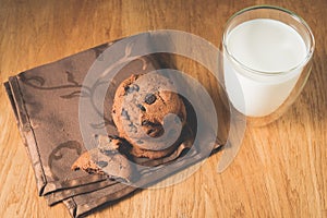 Chocolate cookies and glass of milk on wooden table /Chocolate cookies and glass of milk on wooden table. Top view