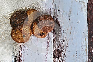 Chocolate cookies on rustic wooden table. Space for text. View top.