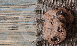 Chocolate cookies on wooden table.