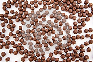 Chocolate corn balls as abstract food background. Top view.
