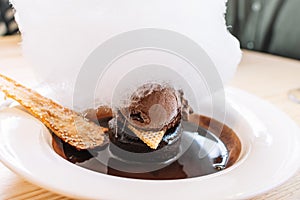 Chocolate coulant or fondant. Melt a delicious pudding with chocolate ice cream and sugar cloud. Delicious dessert close-up