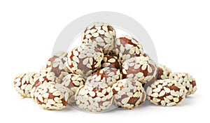 Chocolate covered peanuts and sesame seeds on a white background. Isolated