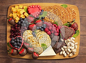 A Chocolate Covered Strawberries and Cheese Sweet Charcuterie Board on a Rustic Wooden Table