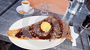 Chocolate crepe pancake with a scoop of ice cream tasty dessert dish serving