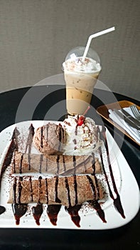Chocolate crepe served with ice cream and whipping cream