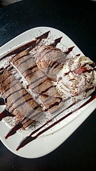 Chocolate crepe served with ice cream and whipping cream