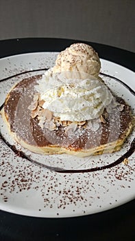 Chocolate crepe served with ice cream and whipping cream