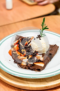chocolate crepe with strawberry and vanilla ice-cream