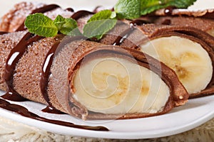 Chocolate crepes with banana filling macro horizontal