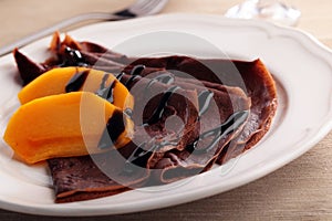 Chocolate crepes with persimmon