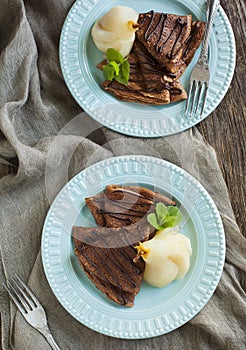 Chocolate crepes with poached pear in syrup