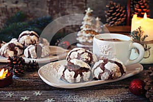 Chocolate Crinkle Cookies in powdered sugar, cup of coffee and Christmas decoration