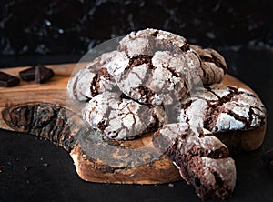 Chocolate Crinkles. Chocolate cookies in powdered sugar on a wooden board